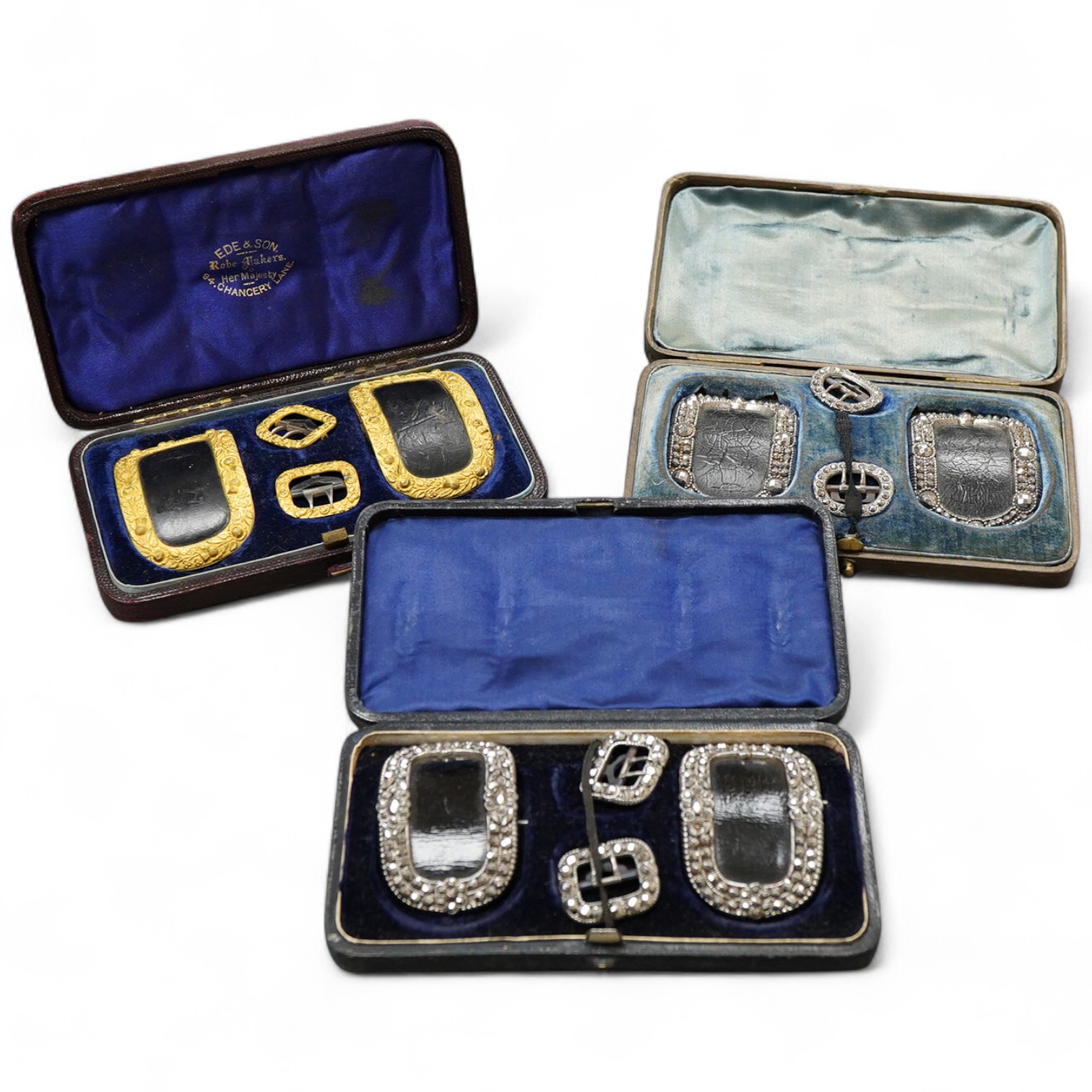 A collection of cased buckles, 19th century, two sets in cut steel, one set in gilt metal, each in a fitted case